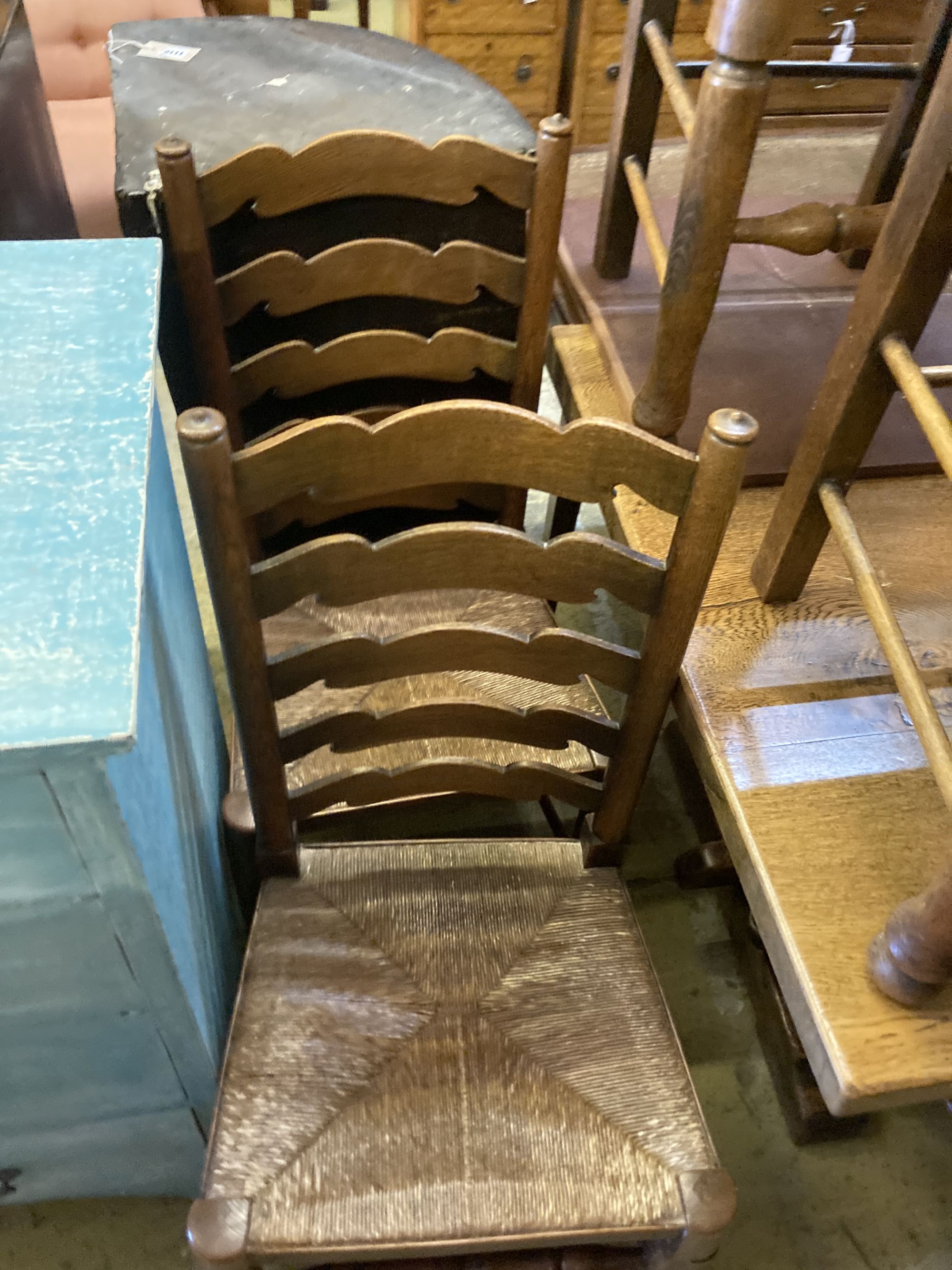 A set of six oak rush seated ladderback dining chairs